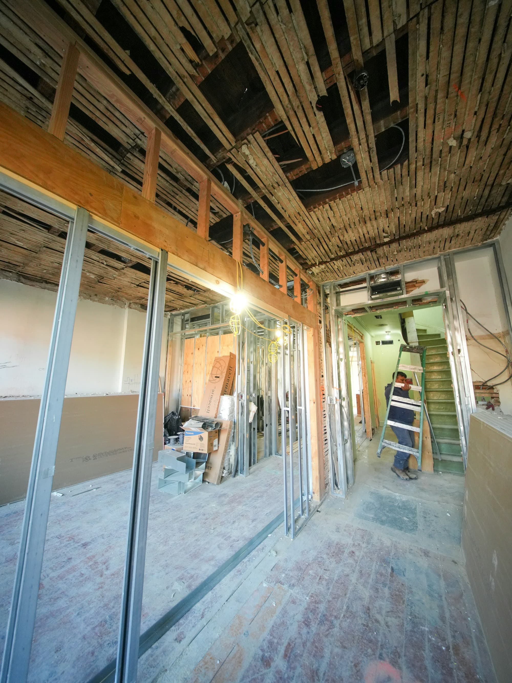Interior building fit-out mid-construction with exposed framing