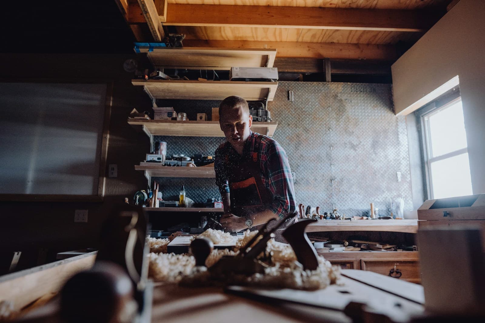 Joinery worker shaping timber in a workshop